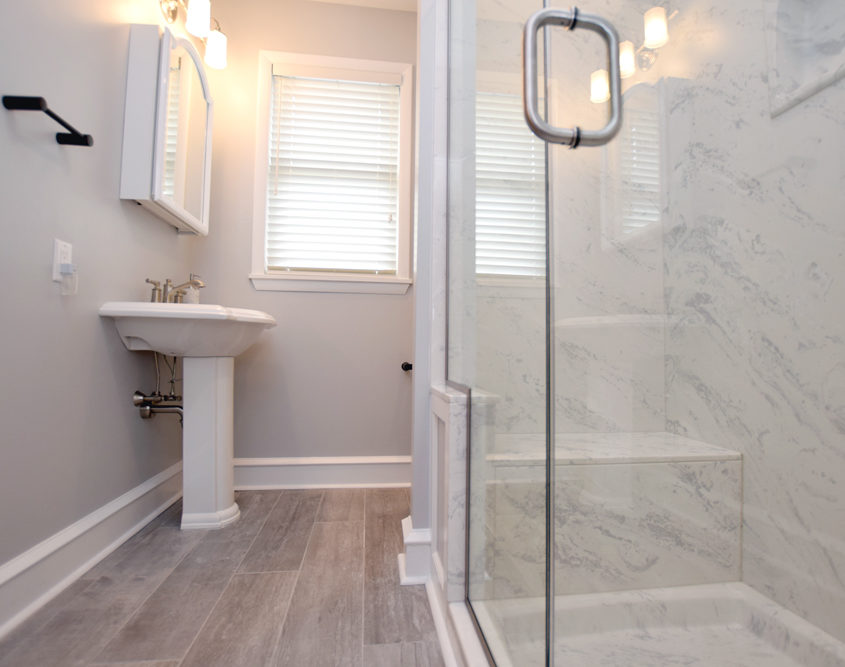 master bathroom sliding shower door and pedestal sink