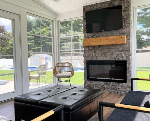 outdoor living room with evolve stone fireplace and mounted television