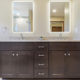 neutral master bathroom double vanity with backlit mirrors