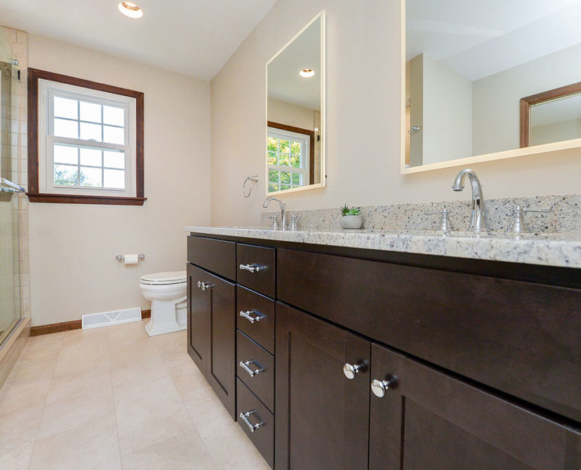 neutral master bathroom double vanity with backlit mirrors