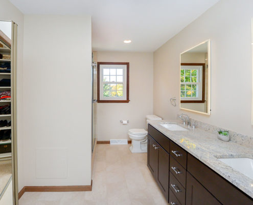 neutral master bathroom double vanity with backlit mirrors