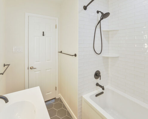 hall bathroom in swedesboro nj with subway tile shower surround and black hardware