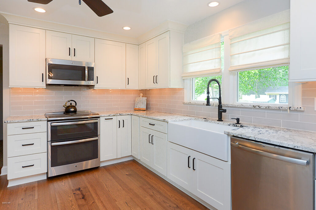 Kitchen remodel, white cabinets, chrome appliances, hardwood floor, natural lighting, sink