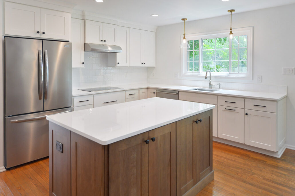 clean modern kitchen remodel with white subway tile and countertops, island with stained cabinets