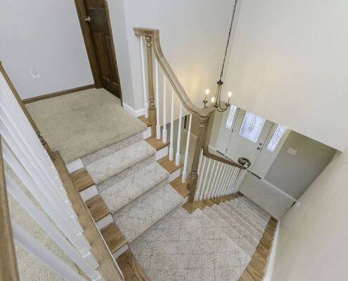 First floor remodel, staircase, wooden stairs, gray walls, gray carpet, wooden banister