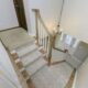 First floor remodel, staircase, wooden stairs, gray walls, gray carpet, wooden banister