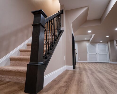 sewell-nj-finished-basement-and-wine-cellar-50-min dark wood stain and wrought iron finished basement stairwell in sewell nj