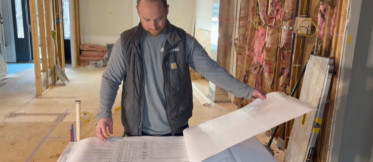 carpenter looking at blueprints ayars complete home improvements top products south jersey