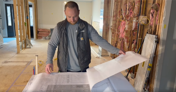 carpenter looking at blueprints ayars complete home improvements top products south jersey