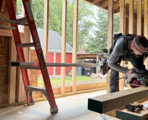 carpenter from ayars on-site setting up structural beams