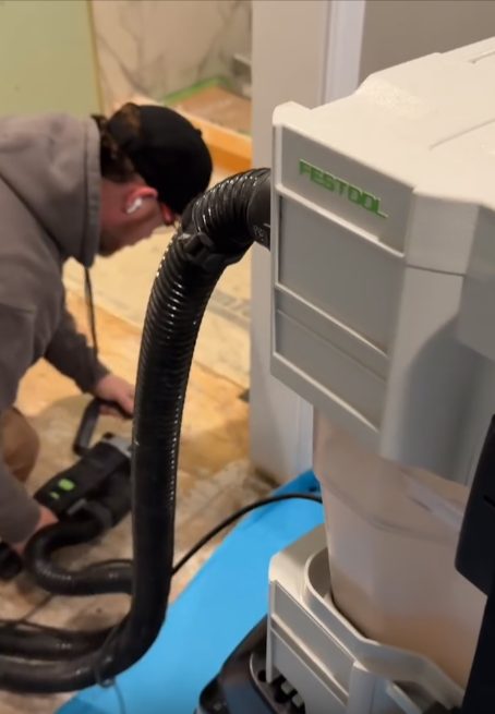 Festool HEPA dust extractor capturing dust at the source on an Ayars job site
